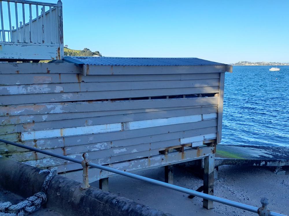 Damaged weatherboards and peeling paint on the Calliope Sea Scouts Hall